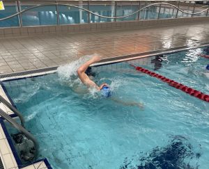 A swimmer in the pool completing a tumble turn