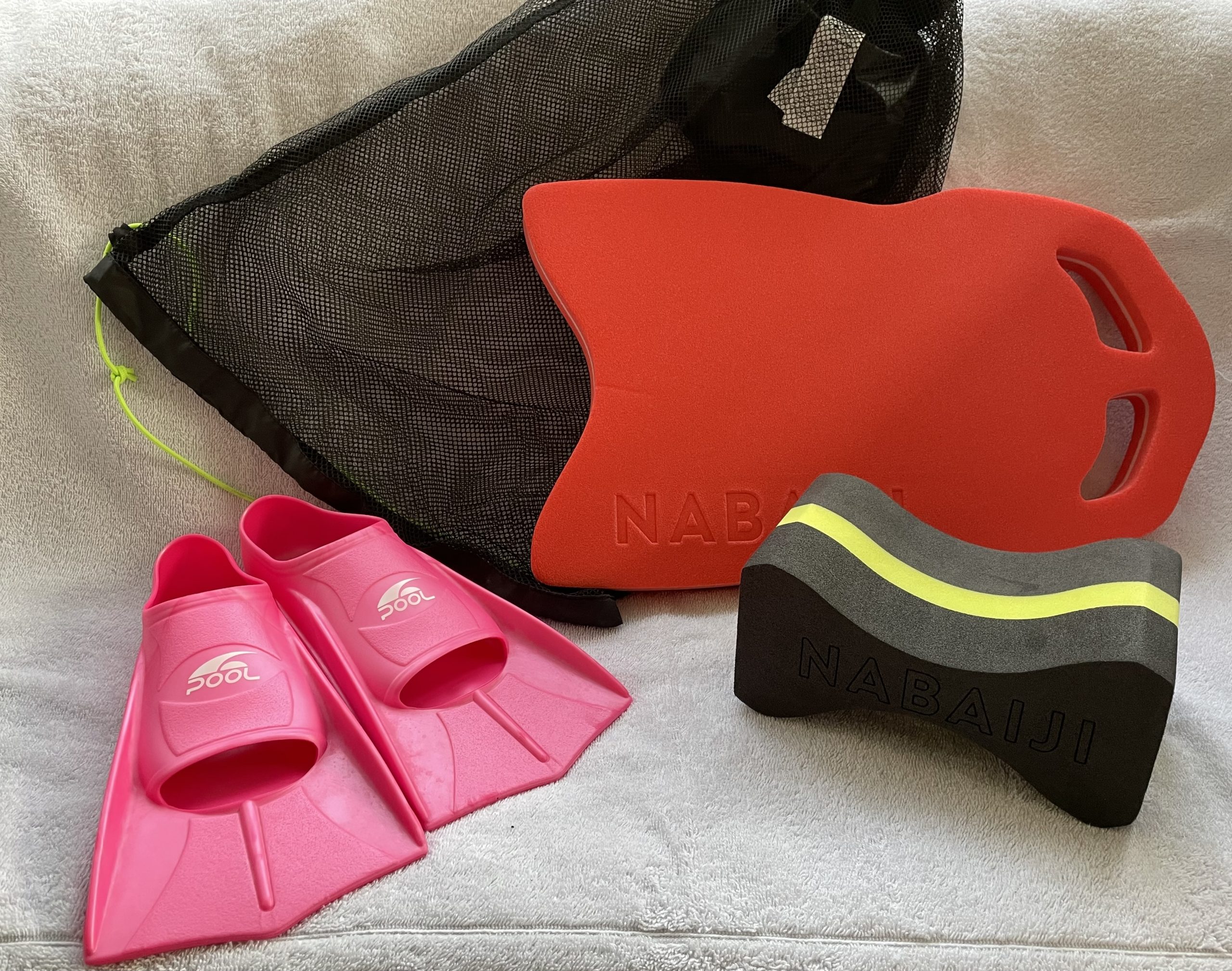 A image of kit bag including bag, short training fins, a float and pool bouy